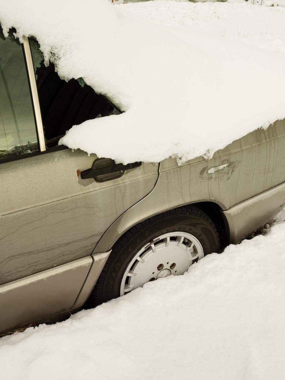 Snow swallows the car in silence.
White presses against metal.
The wheel disappears beneath the cold.
No movement.
Just weight.